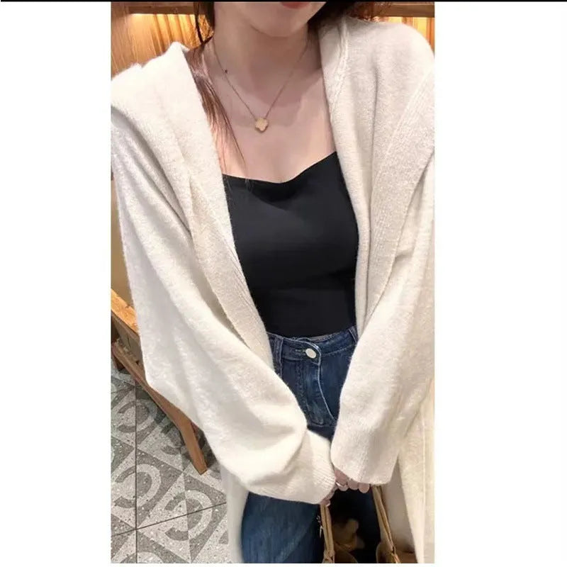 Women's long brown hooded knitted cardigan with a below-the-knee length and loose fit.
