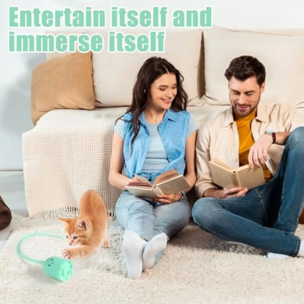 Green automatic cat wand toy with silicone tail on floor for indoor cat play