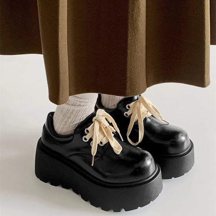 Matte black women's retro lace-up shoes with a thick sole and a muffin heel.