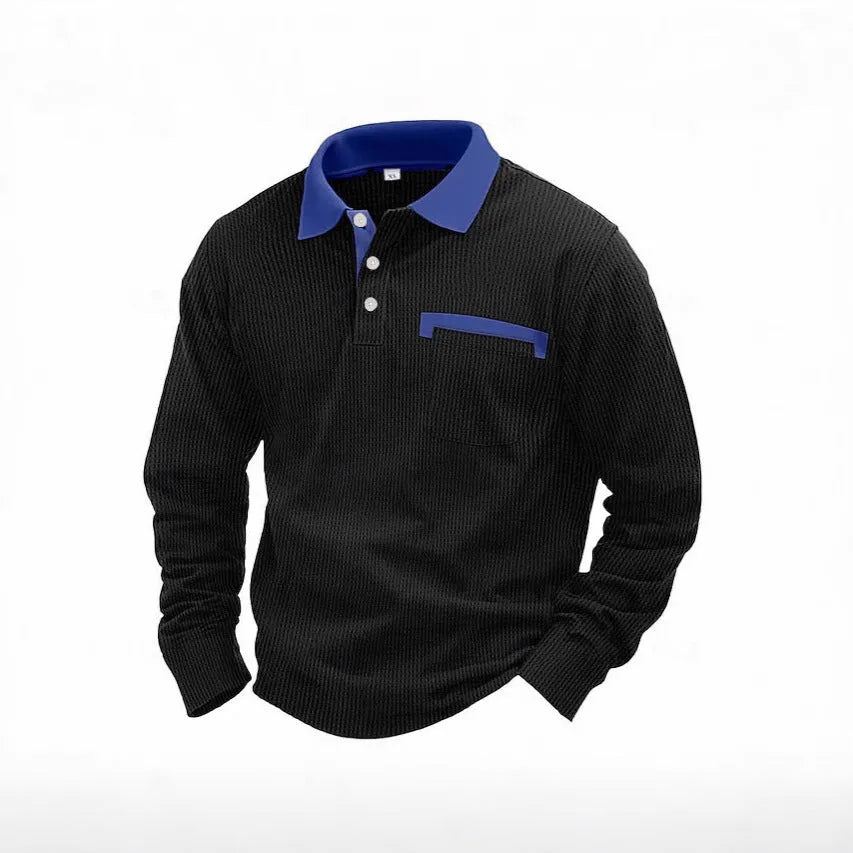 Man wearing a loose-fit dark grey waffle-texture long-sleeved polo shirt with an asymmetric style detail.
