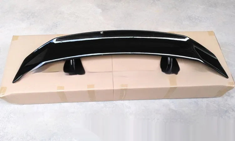 Universal punch-free car spoiler tail wing in ABS plastic on a vehicle.