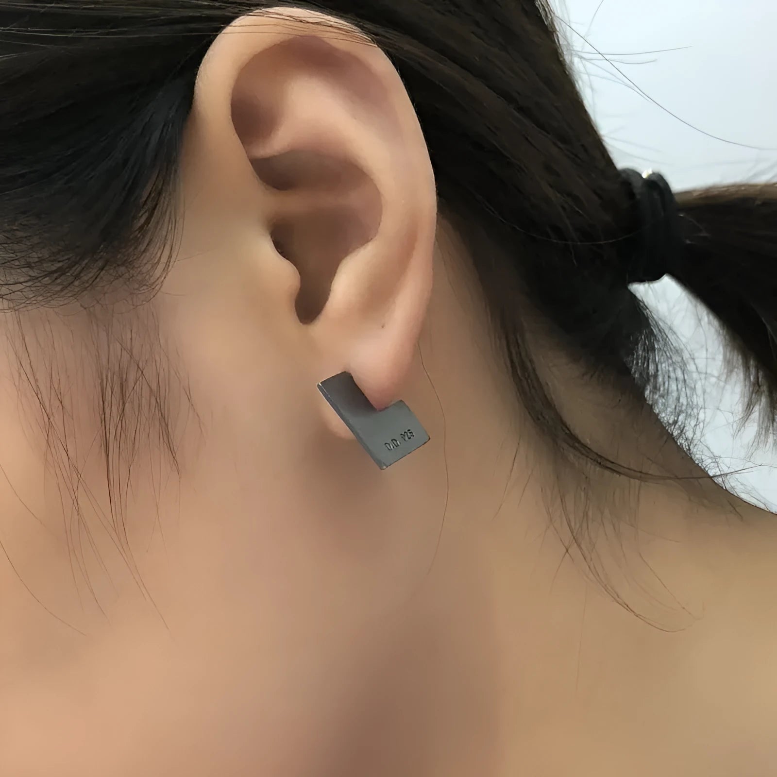 Close-up of a pair of oxidation black geometric square stud earrings made from 925 sterling silver.