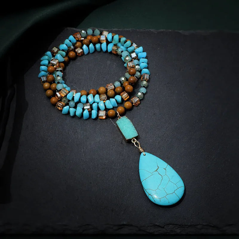 Blue turquoise gem inlaid drop pendant on a long ball bead necklace chain