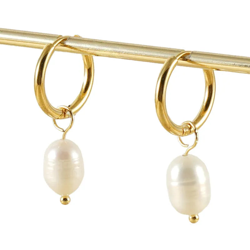 Gold geometric stainless steel earrings with a central white cultured pearl on a post.