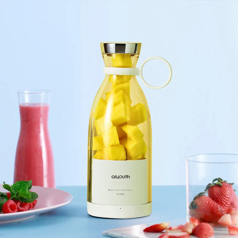 Handheld mini electric juicer in pink with USB charging cable