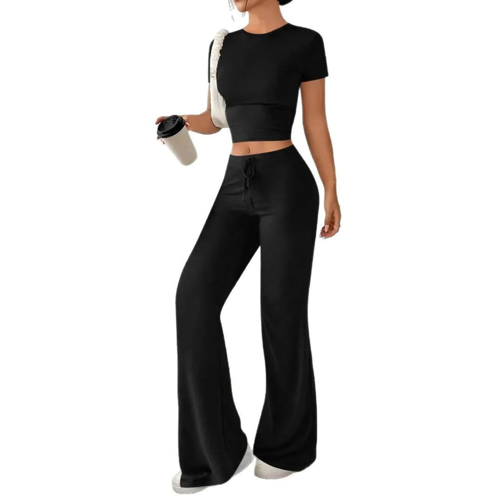 Black high waist trousers and short sleeve t-shirt co-ord suit set on a hanger.