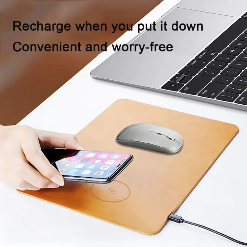Brown leather wireless charging mouse pad with Micro USB cable on a wooden desk.