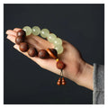 Rosewood bracelet with carved Fu character design and flexible ring construction in amass fortunes colour