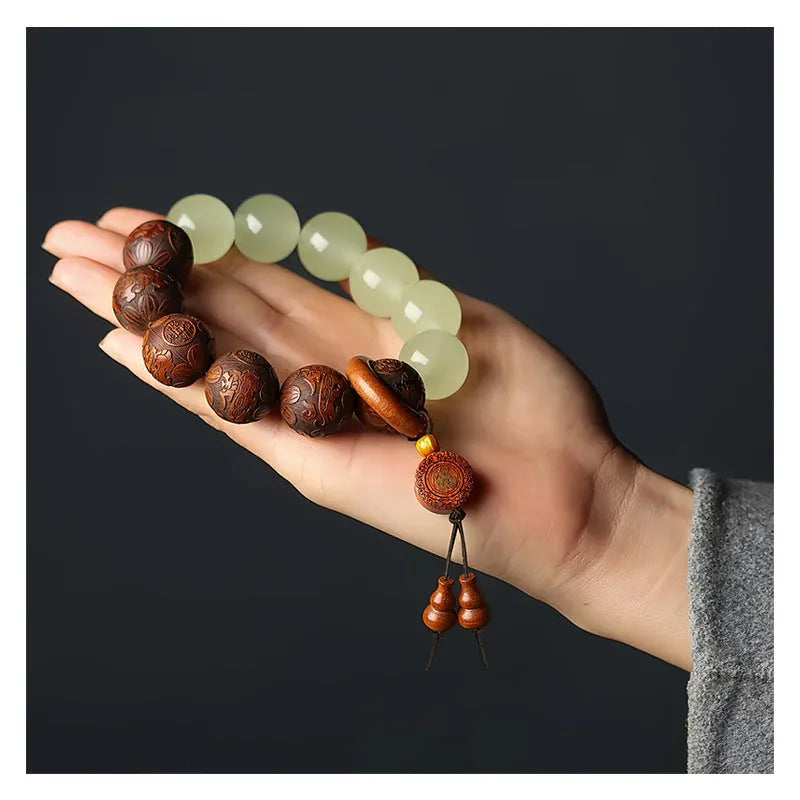Rosewood bracelet with carved Fu character design and flexible ring construction in amass fortunes colour