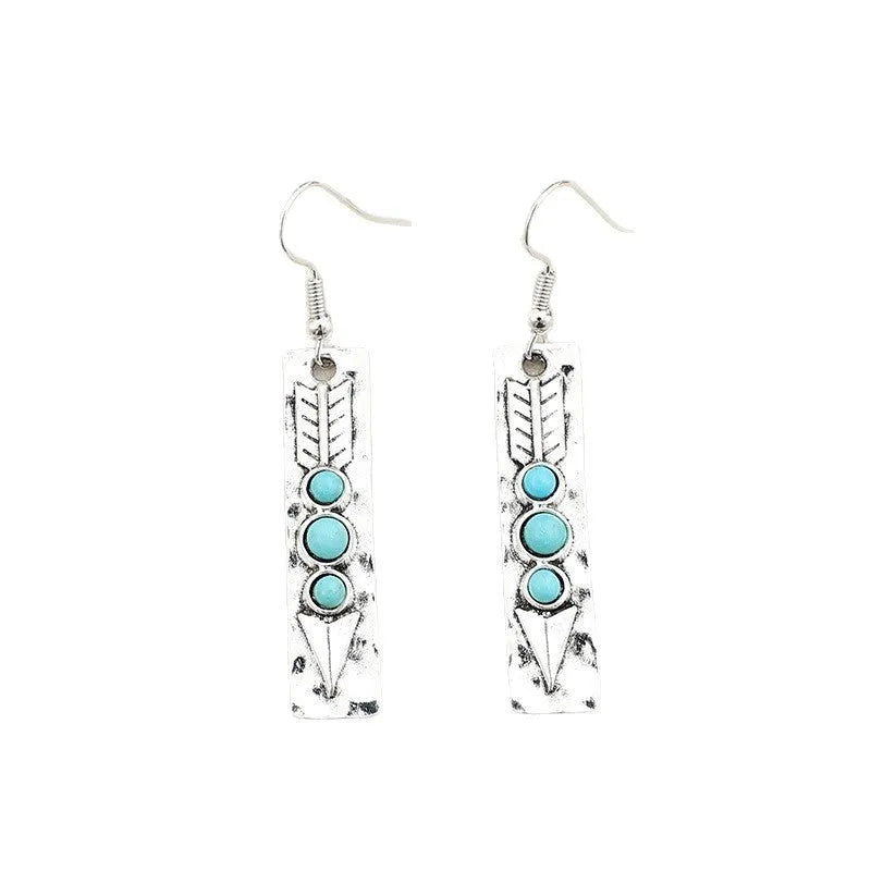 Long silver geometric drop earrings with blue turquoise stone inlays on a retro-style setting.