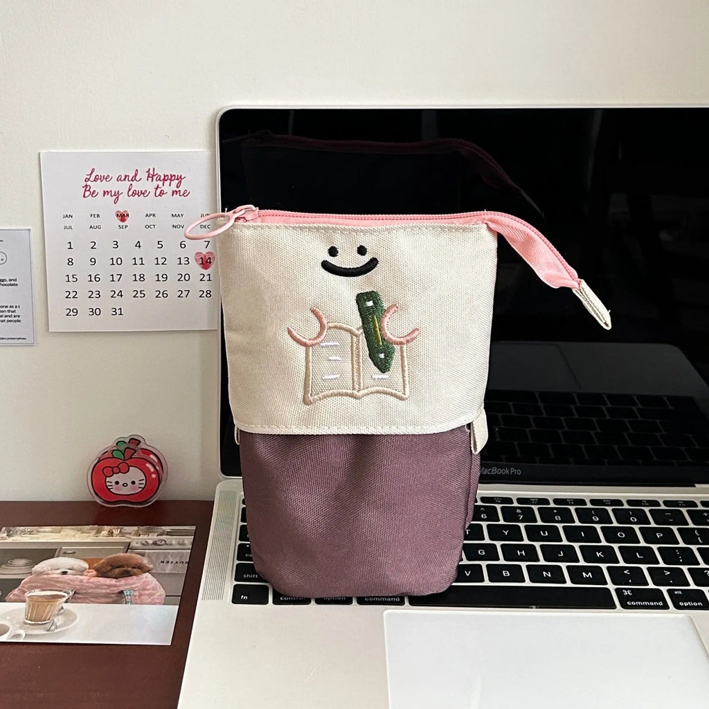 Brown cartoon pattern collapsible pencil case with zipper closure showing interior space