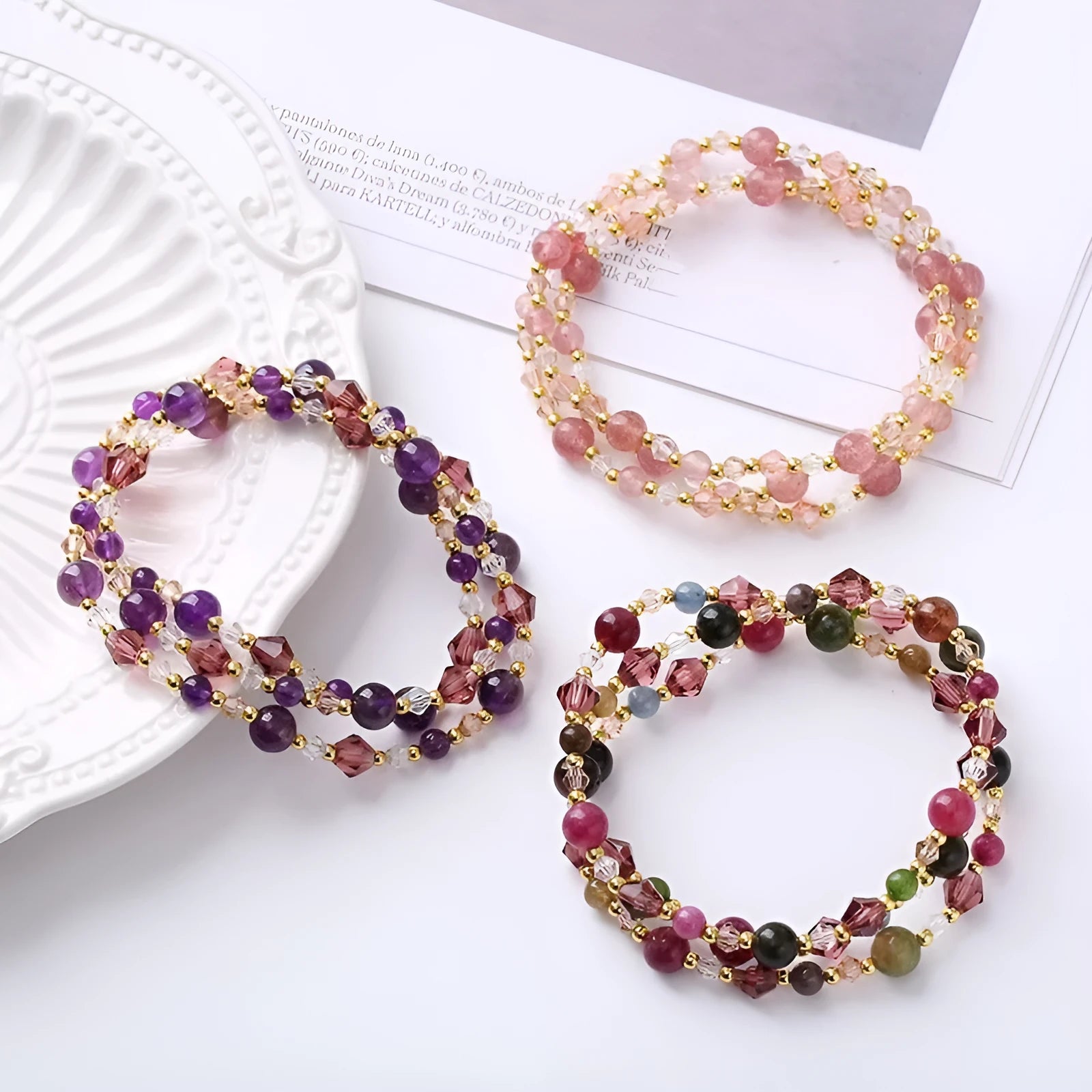 Colourful three-ring crystal bracelet for women with amethyst, strawberry quartz, and tourmaline beads on an adjustable rope.
