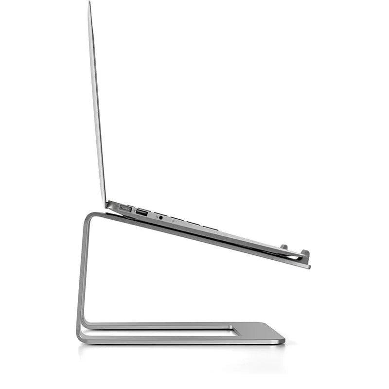 Black aluminium laptop stand with angled platform on a wooden desk