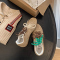 Women's retro German training shoes in milky white with flat heel and front lace-up design.