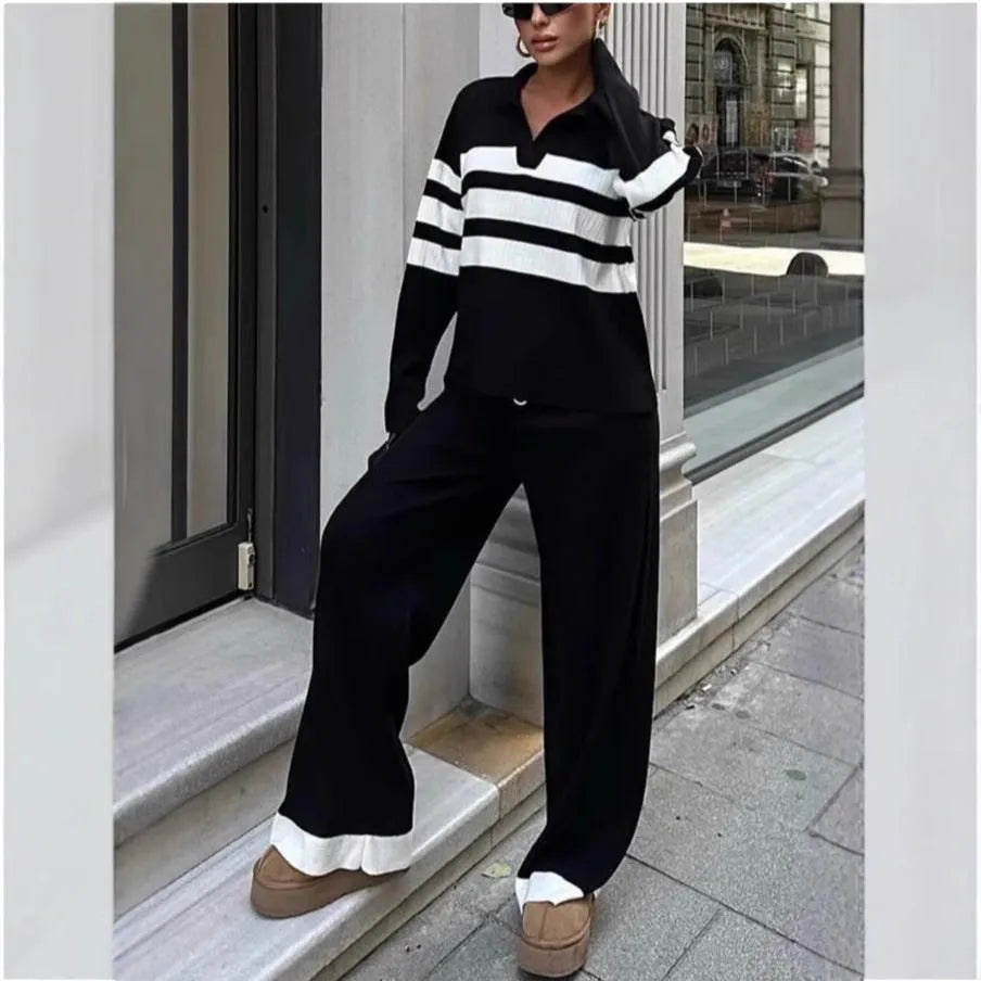 Women's black and white striped knitted two-piece set with a polo collar, featuring a long-sleeve top and trousers.