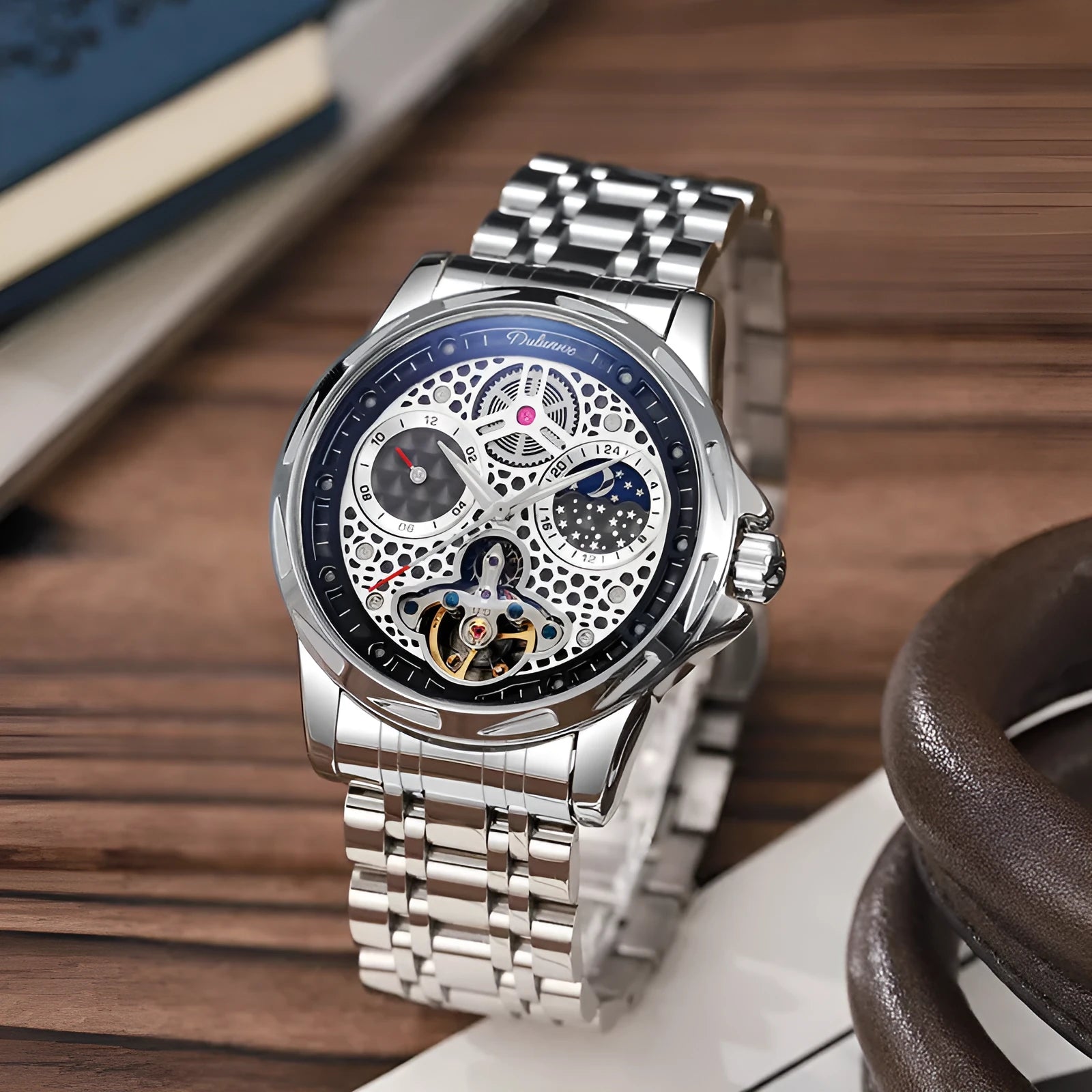 Men's automatic watch with luminous hands on a steel bracelet, showing a black dial and case.