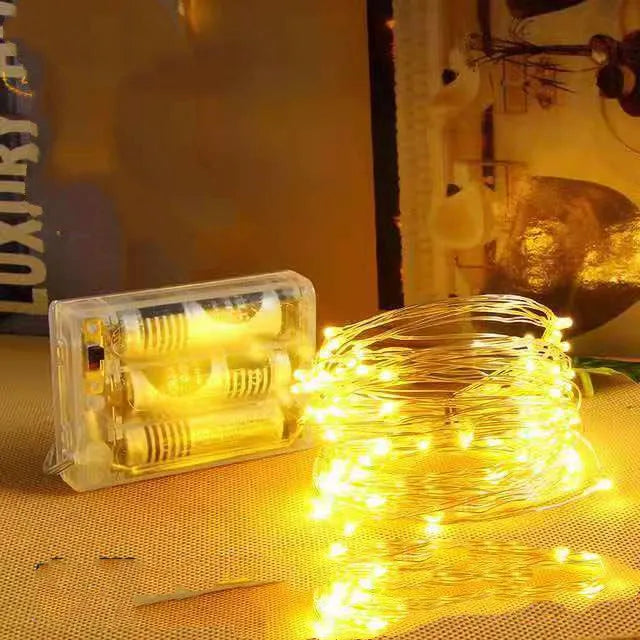 12-metre long copper wire LED string lights with 120 bulbs and a USB plug, displayed with a light post.