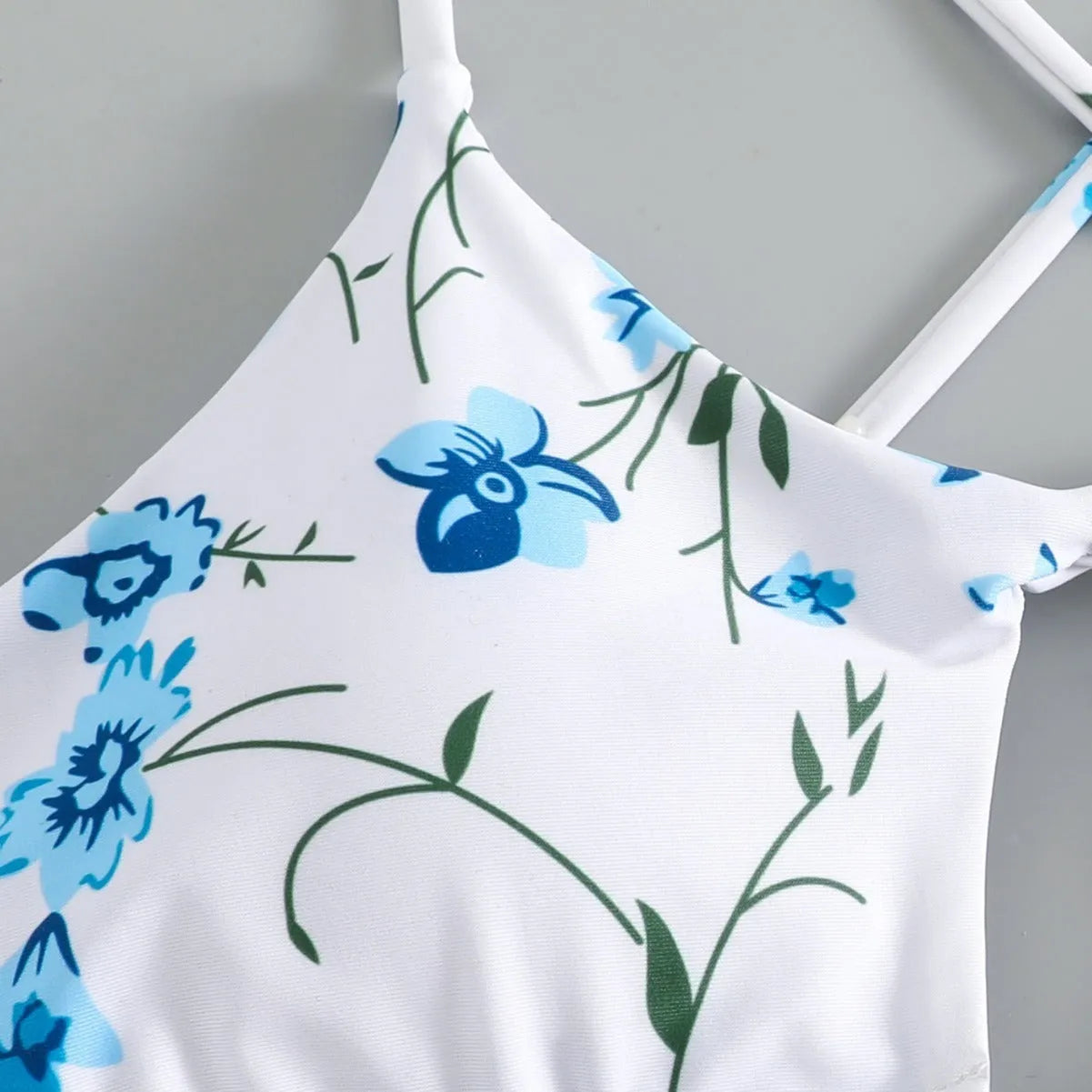 Women's floral print swimsuit set with triangle tie-neck top and matching shorts