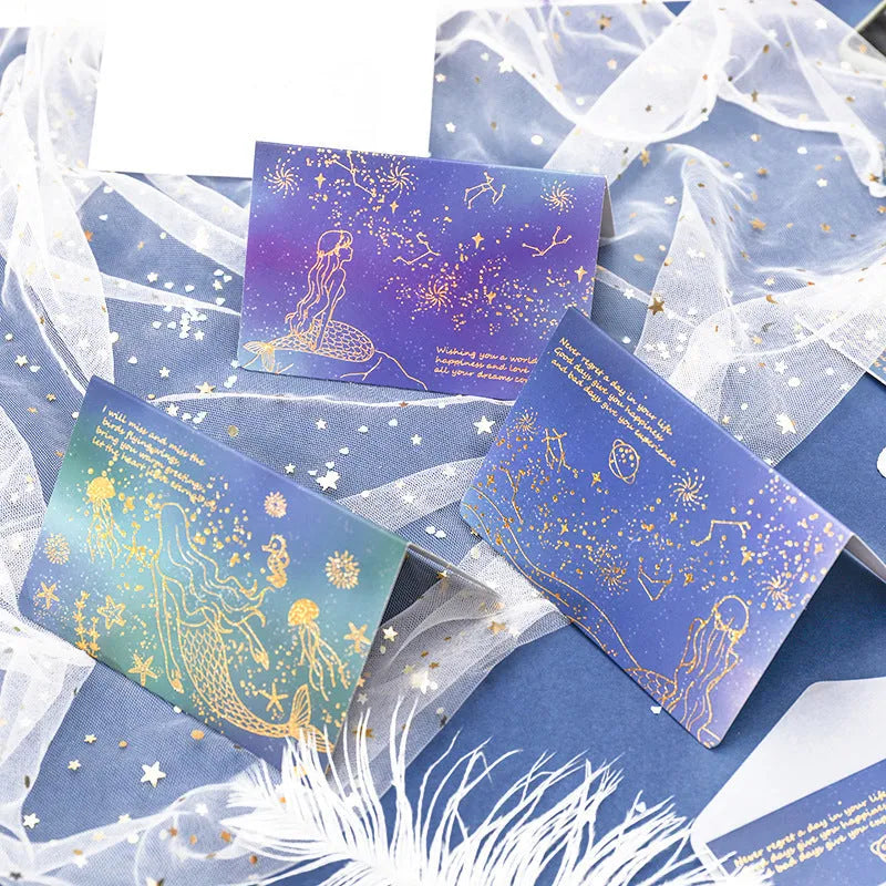 Three decorative paper envelopes with bronzing mermaid design in assorted colours