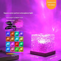 Crystal table lamp projecting blue water ripple light effect onto a wall, with remote control.