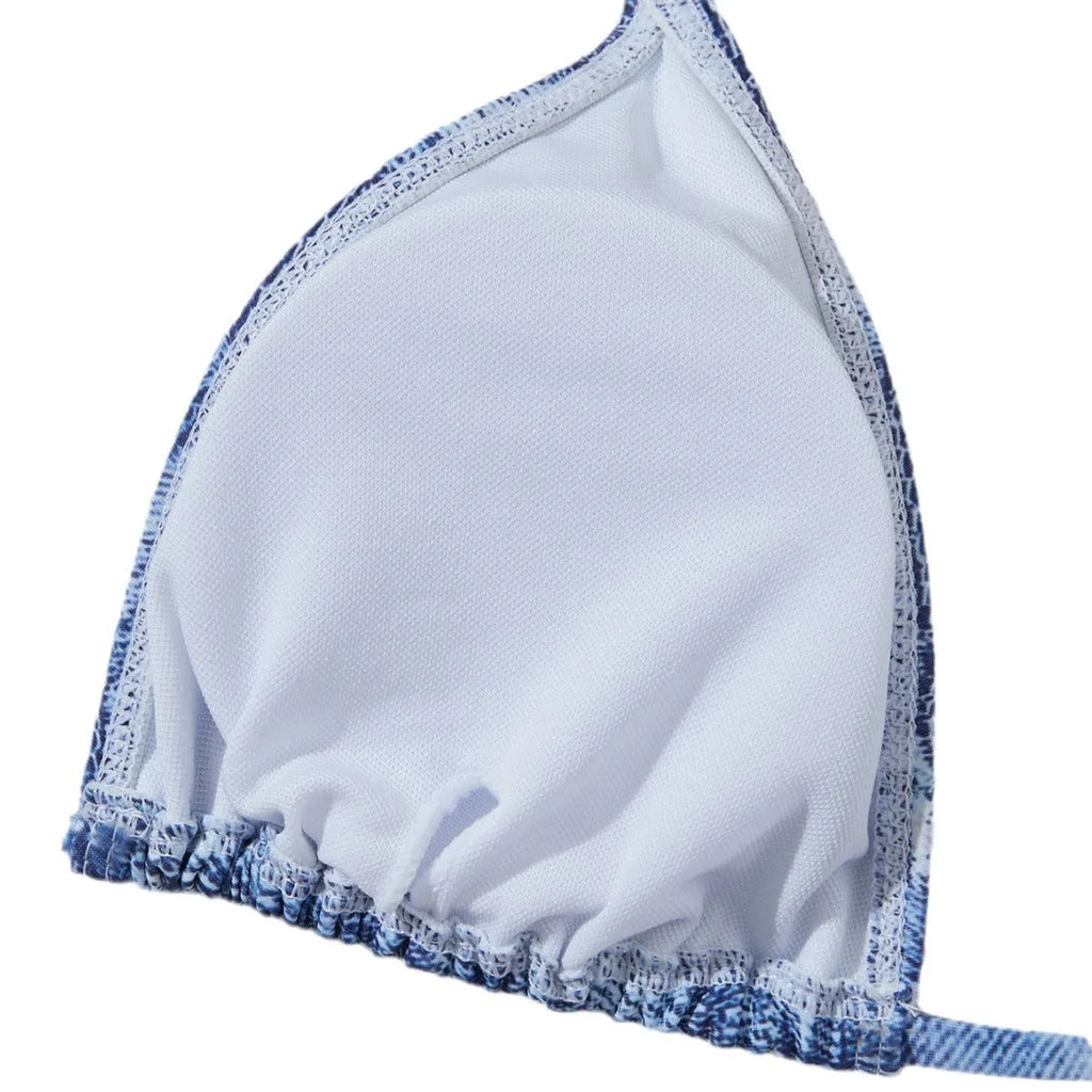 Denim blue printed women's bikini set with strap design, shown on a model.
