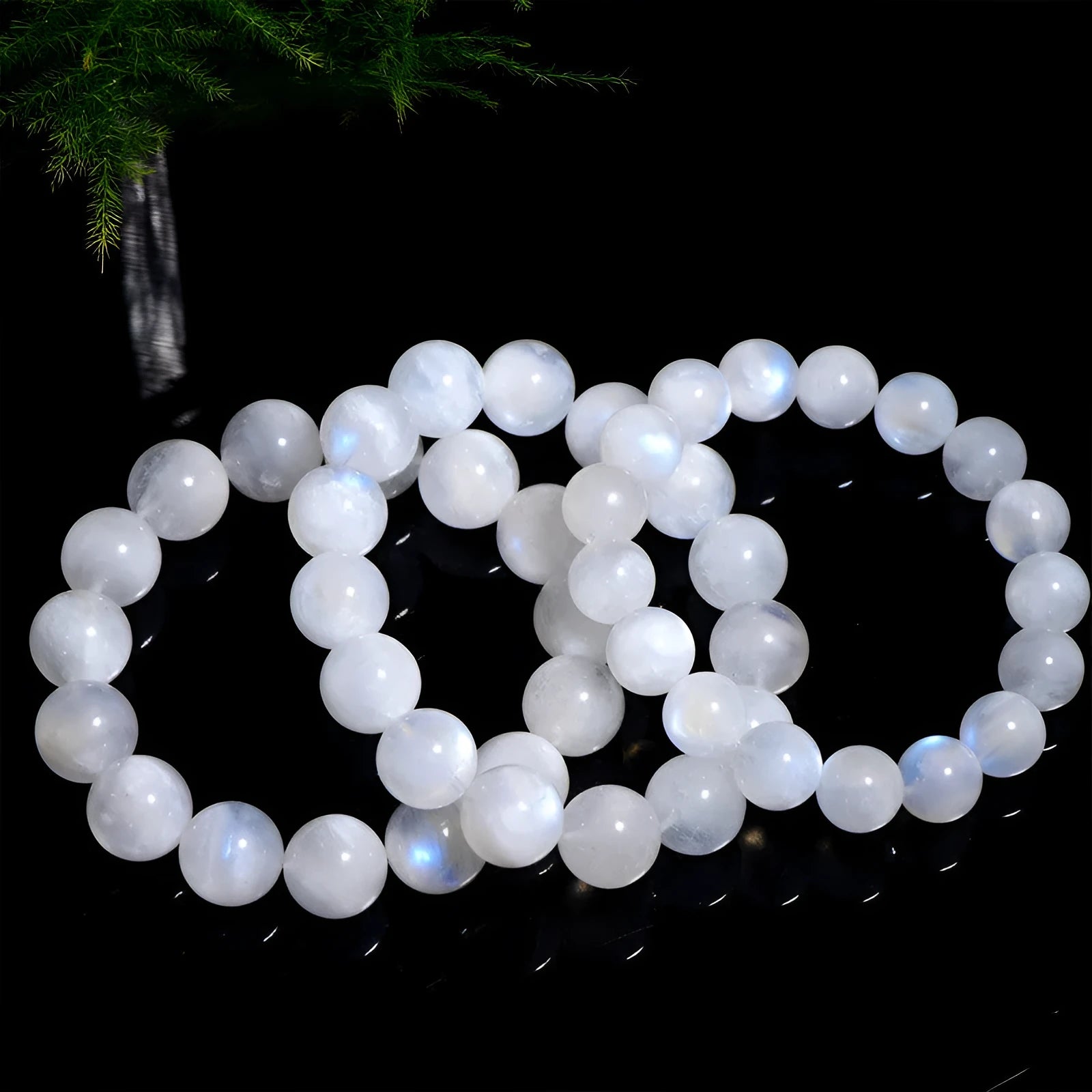 Natural blue moonlight polished moonstone round bead bracelet on wrist.