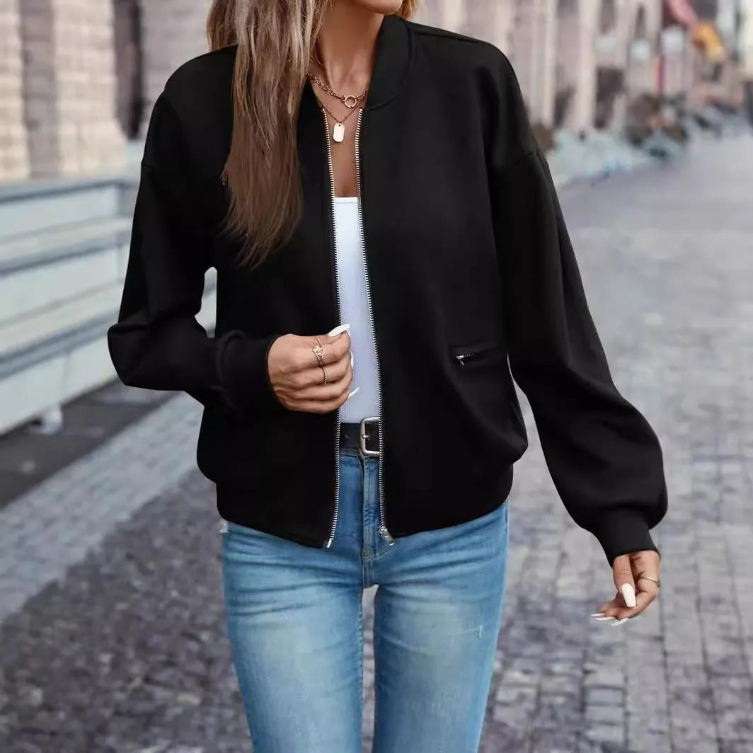 Women's solid black casual zip jacket with long sleeves, shown on a model.