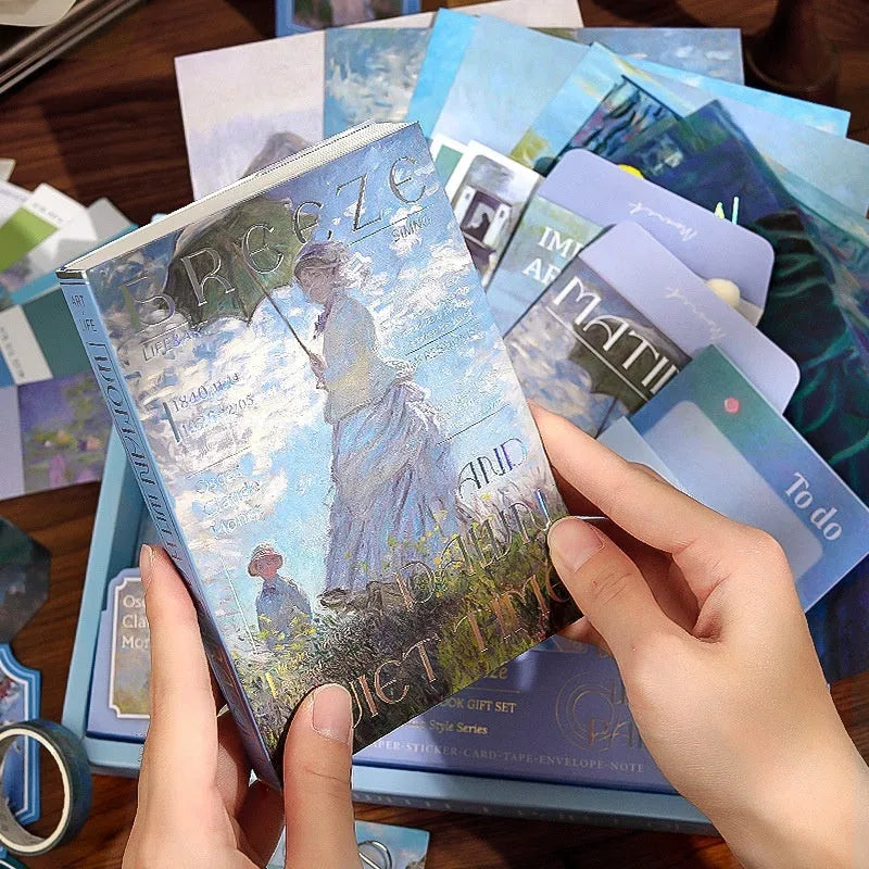 Hand Account Suit creative journal gift box open showing A6 grid notebook, paper stickers, cards, and photo frames.