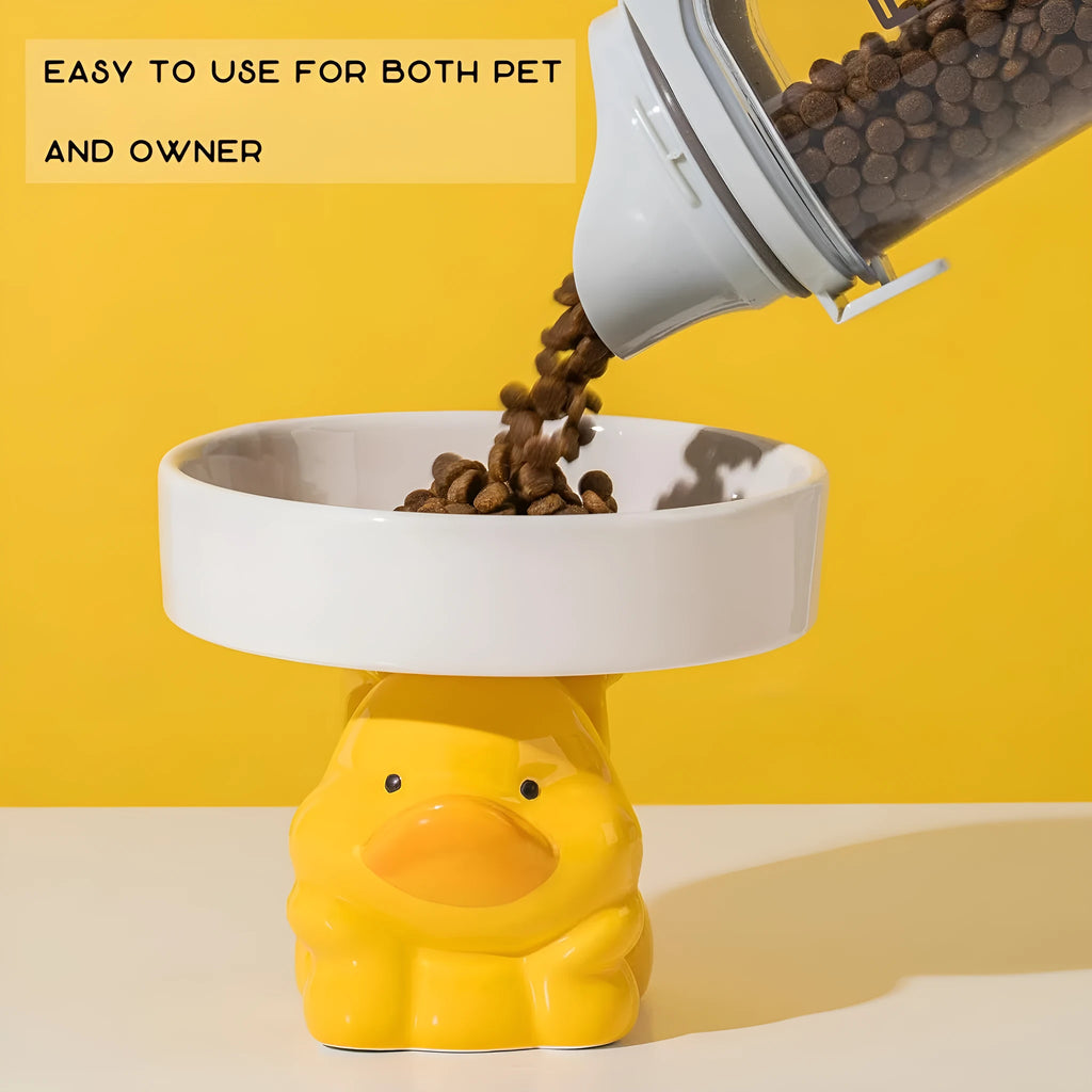 White ceramic raised cat bowl with a bear design, showing its elevated stand and wide feeding dish.