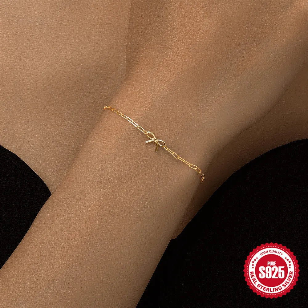 Gold tone S925 sterling silver bracelet with glossy heart charm and clip chain fastening