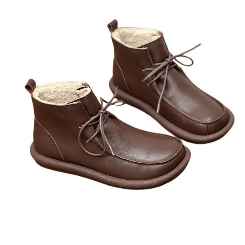 Women's casual cowhide boots with velvet lining in black and coffee colours showing round toe and flat heel design