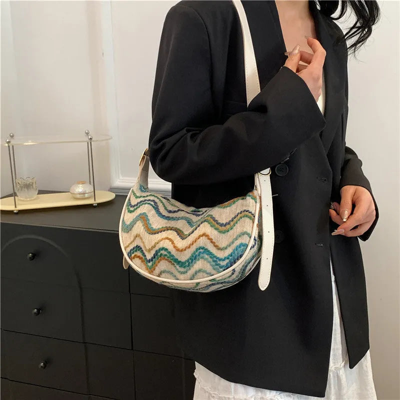 Women's woven straw crossbody bag showing internal phone pocket and document compartment