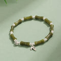 Electroplated bamboo strawberry crystal bracelet for women in green aventurine, showing natural stones on a bracelet.