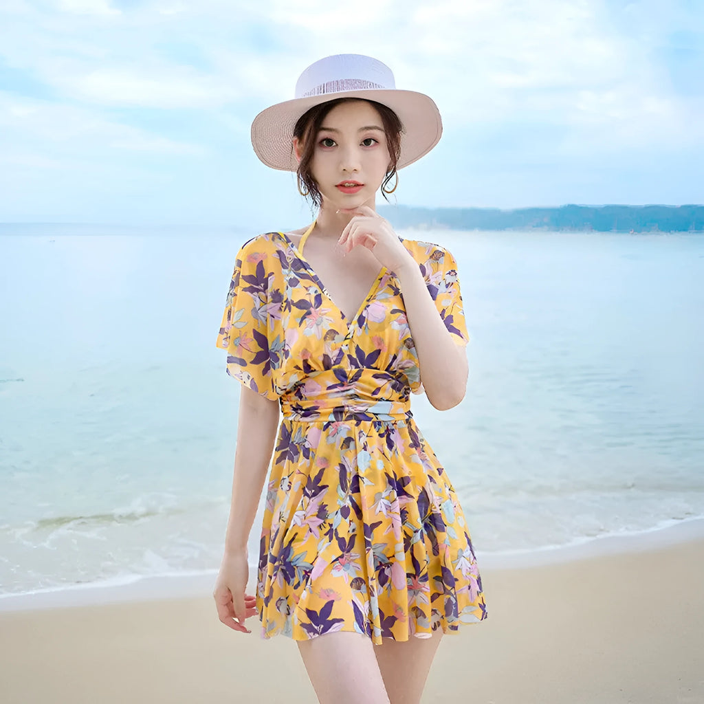 Yellow floral print women's one-piece swimsuit showing front design and polyester fabric construction