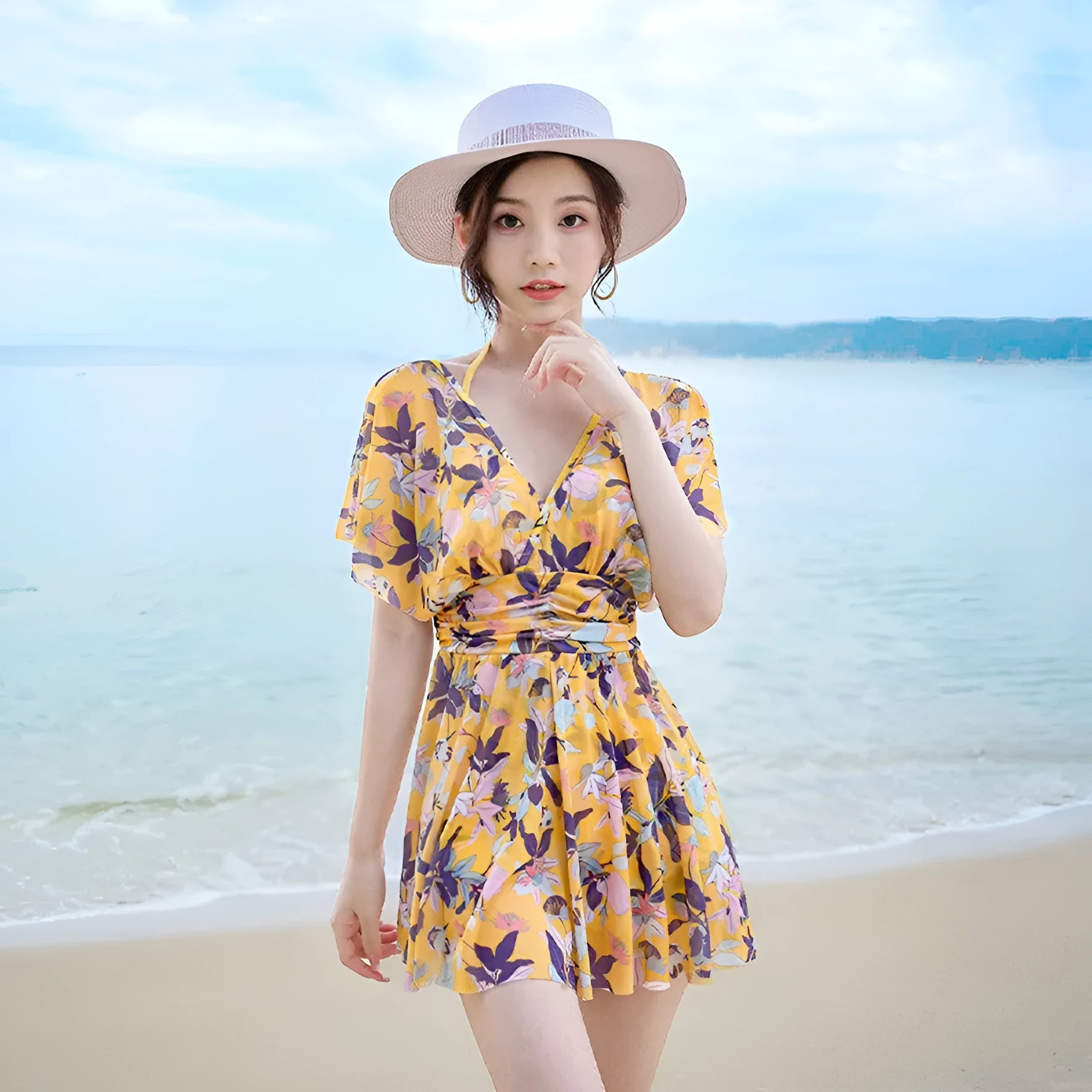 Yellow floral print women's one-piece swimsuit showing front design and polyester fabric construction