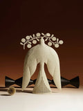 Handmade iron flying bird ornament in ancient Chinese style on a wooden surface.