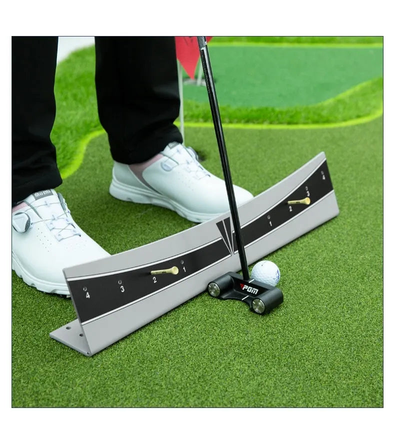 Close-up of an adjustable PVC golf putter trajectory balance simulator on a flat surface.
