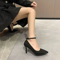 Black and creamy white women's stiletto heel pumps with buckle closure and skull pattern.