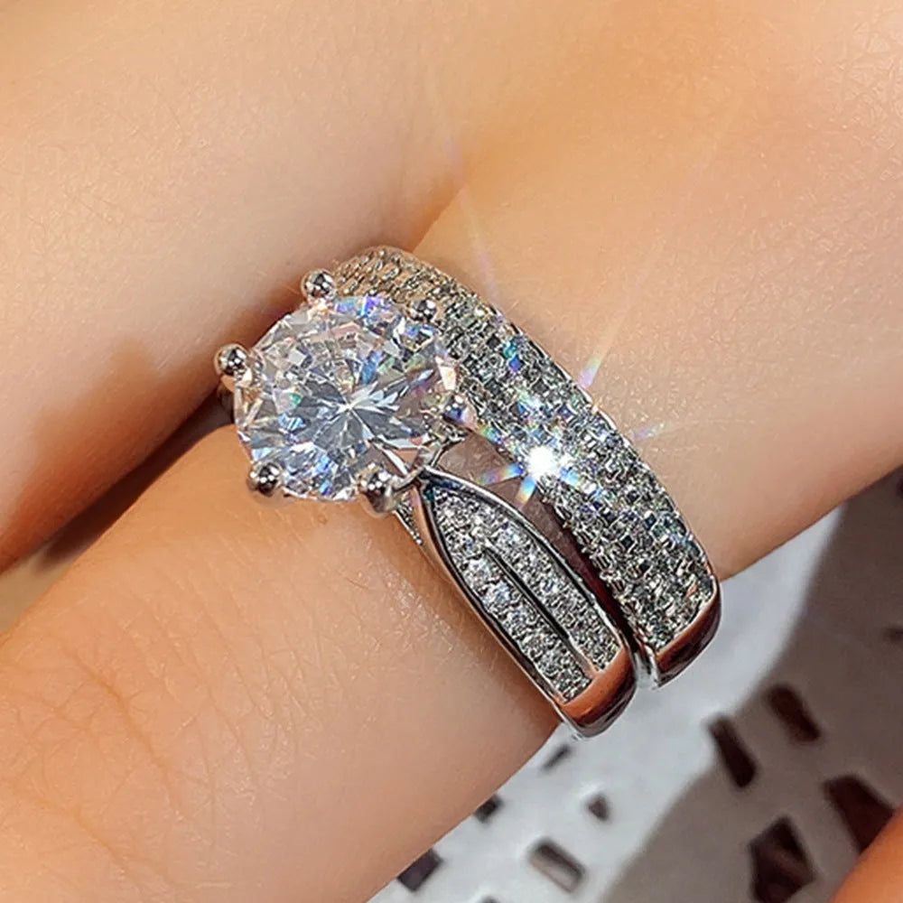 White gold colour alloy geometric wedding ring bracelet with round detail on a hand.