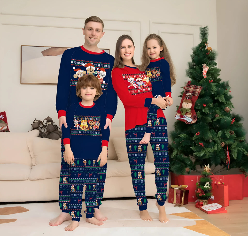 Family wearing matching red plaid Christmas pyjamas with deer print, including adults, children, and a dog.