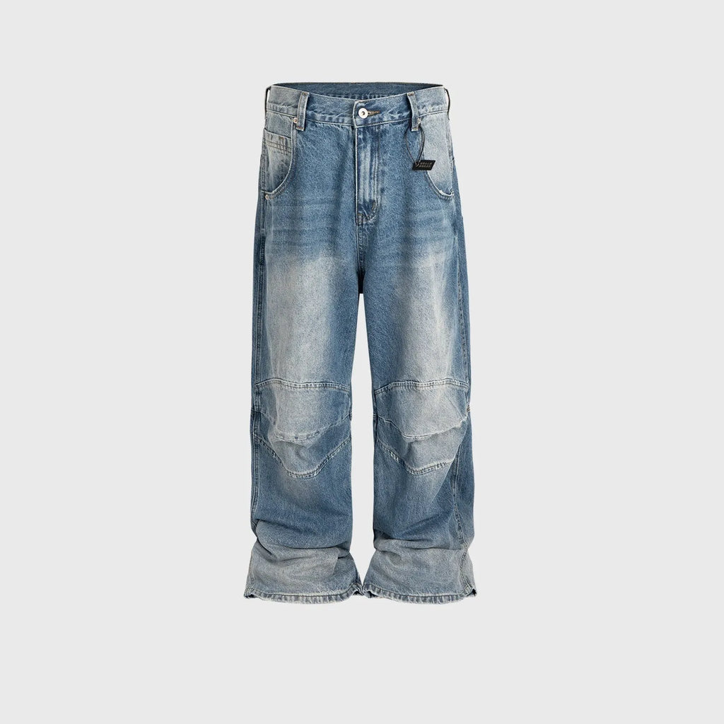 Men's light blue baggy jeans with front pleats and a straight-leg fit on a plain background.