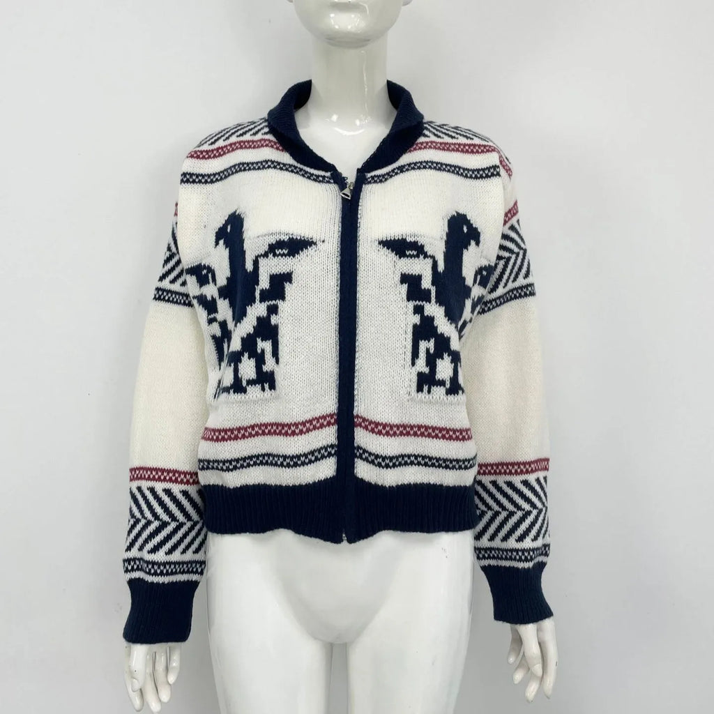 White women's cardigan with front zipper, lapel collar, and contrasting stripe jacquard pattern.
