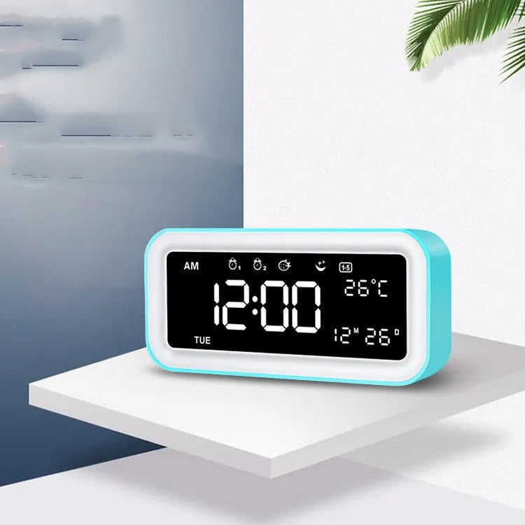 Blue rectangular LED digital alarm clock with multicoloured ambient light display.