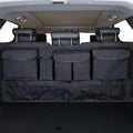 Black car boot hanging storage organiser made of Oxford cloth with a handle, shown hanging.