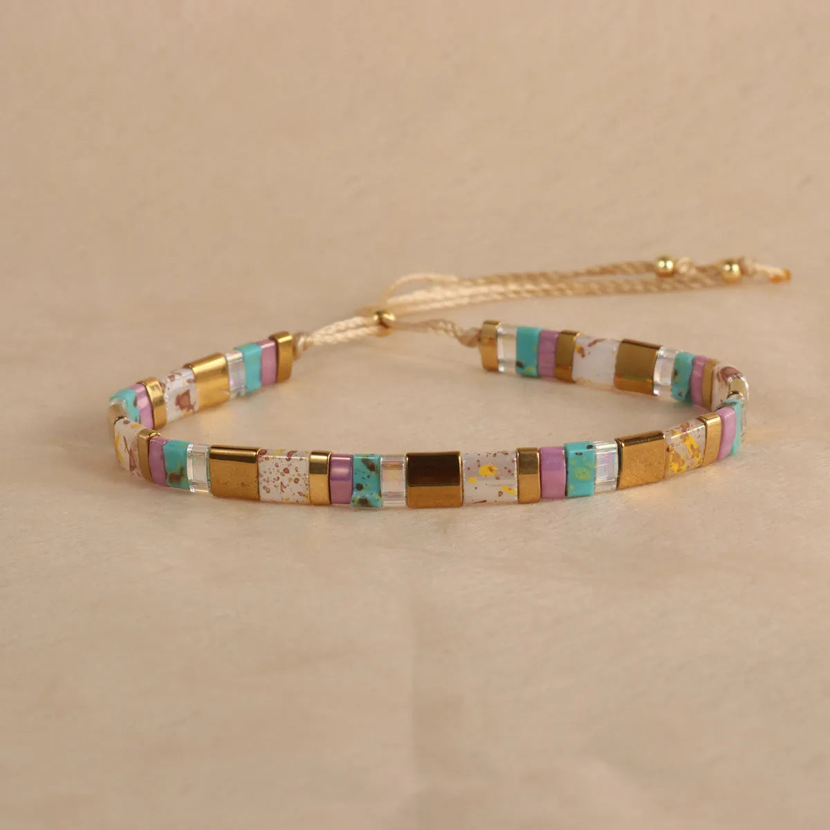 Geometric glass bead bracelet in milky white, black, retro green, light blue, or red colours.