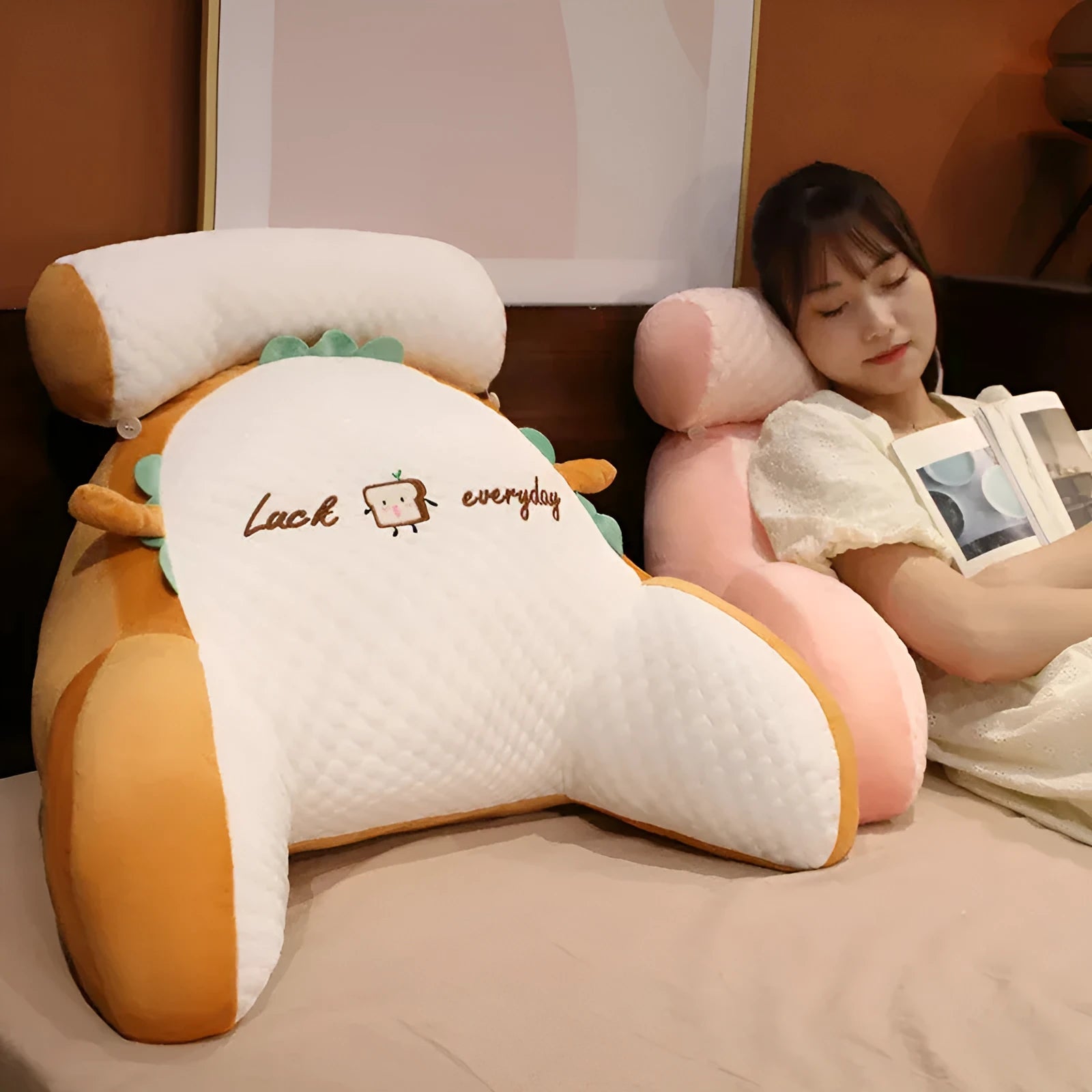 Triangle-shaped fluffy reading cushion on a chair, showing embroidered husky design and detachable cover.