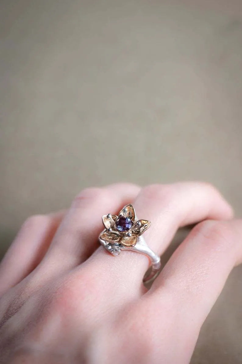 Silver two-tone floral geometric alloy women's ring shown on a white background.