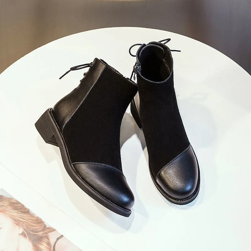 Black women's knee-high Martin boots with side zip and round toe.