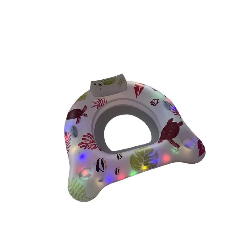 White luminous U-shaped inflatable float seat glowing in a swimming pool at night.