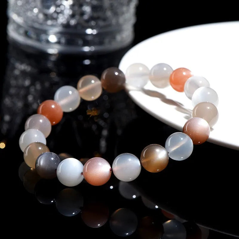 Natural colourful moonlight bracelet with 8mm moonstone beads on a wrist.